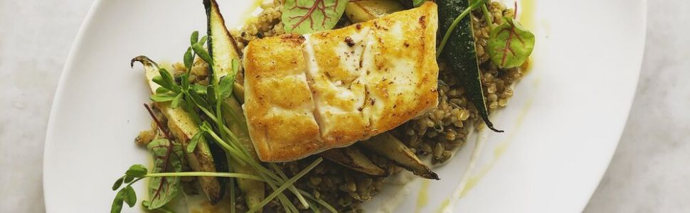 plate of seafood on some greens